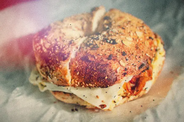 A toasted everything bagel sandwich filled with egg and cheese.