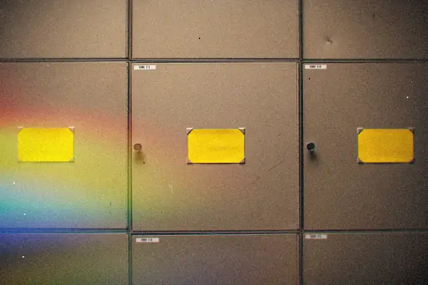 Gray steel cabinet doors marked with blank yellow labels.