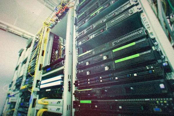 A rack of servers and network gear with cables running down the side.